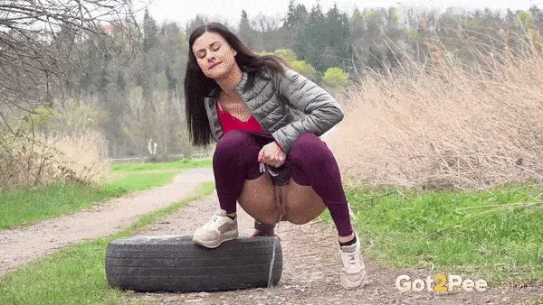 european hottie relieves her piss desperation near an old tyre on a makeshift track porn gif