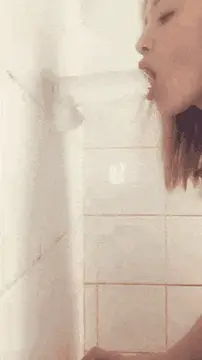 hottie sucking a dildo in the shower porn gif