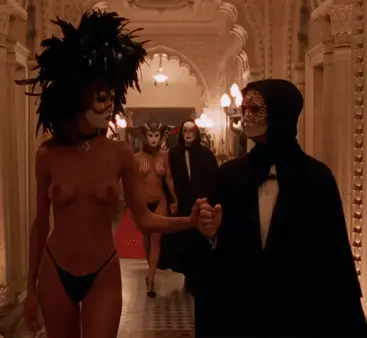 a hedonistic lady who cannot wait to enter the pleasure rooms taking a flirtous look at other excited couples  - eyes wide shut orgy porn gif