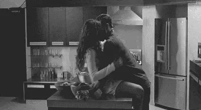 b&w couple making out while she's on the kitchen counter porn gif