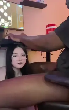 Goth girl giving head while playing games
