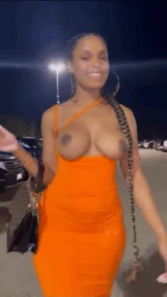 sexy black babe shows off her tits in the parking lot