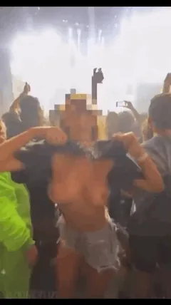 anonymous blonde flashing tits at a concert