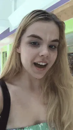 adorable teen walking through a mall after taking a load of cum on her face.