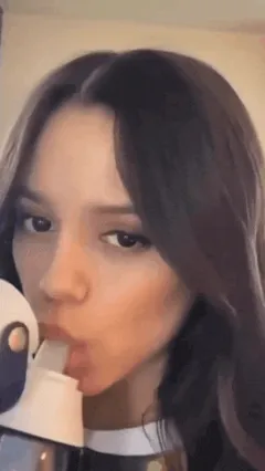 jenna ortega sucks on the nipple of her drink cup to quench her thirst with some refreshingly cold water