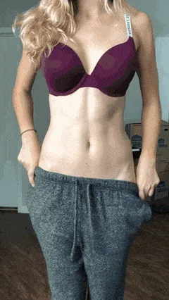 cute blonde stripping her clothes off